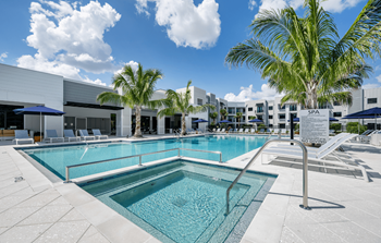 Resort-inspired pool with heated spa and summer kitchen